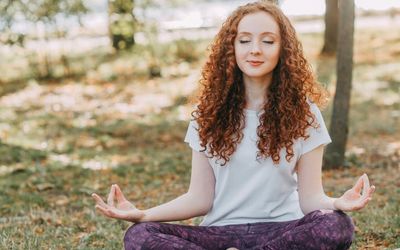 Person stretching gently in a calm, minimalist environment.
